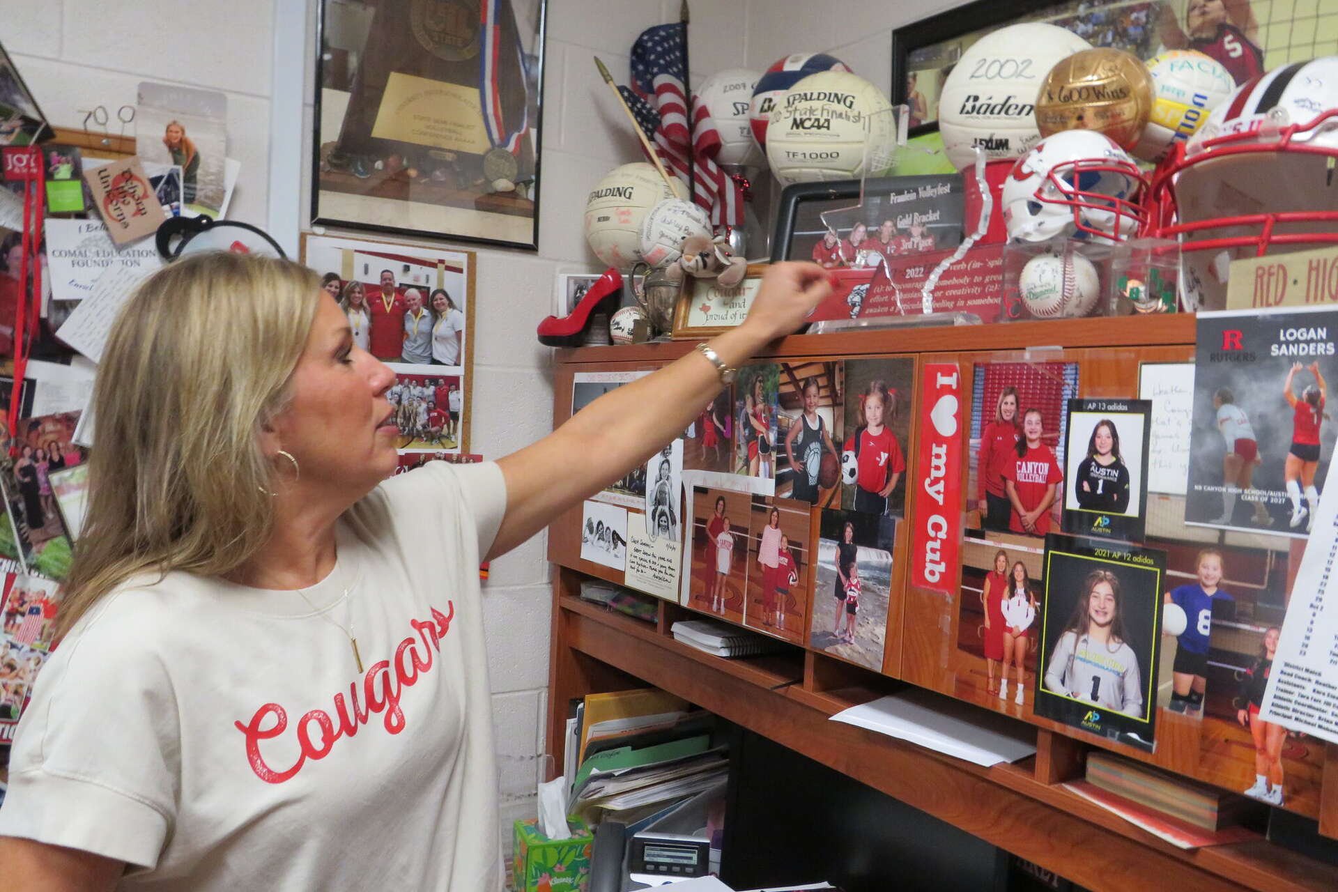 Memorabilia from decades of coaching lines the office of Canyon High School volleyball coach Heather Sanders in New Braunfels. The photos and keepsakes reflect 28 years leading the Cougars as she prepares to retire after 33 years in education.