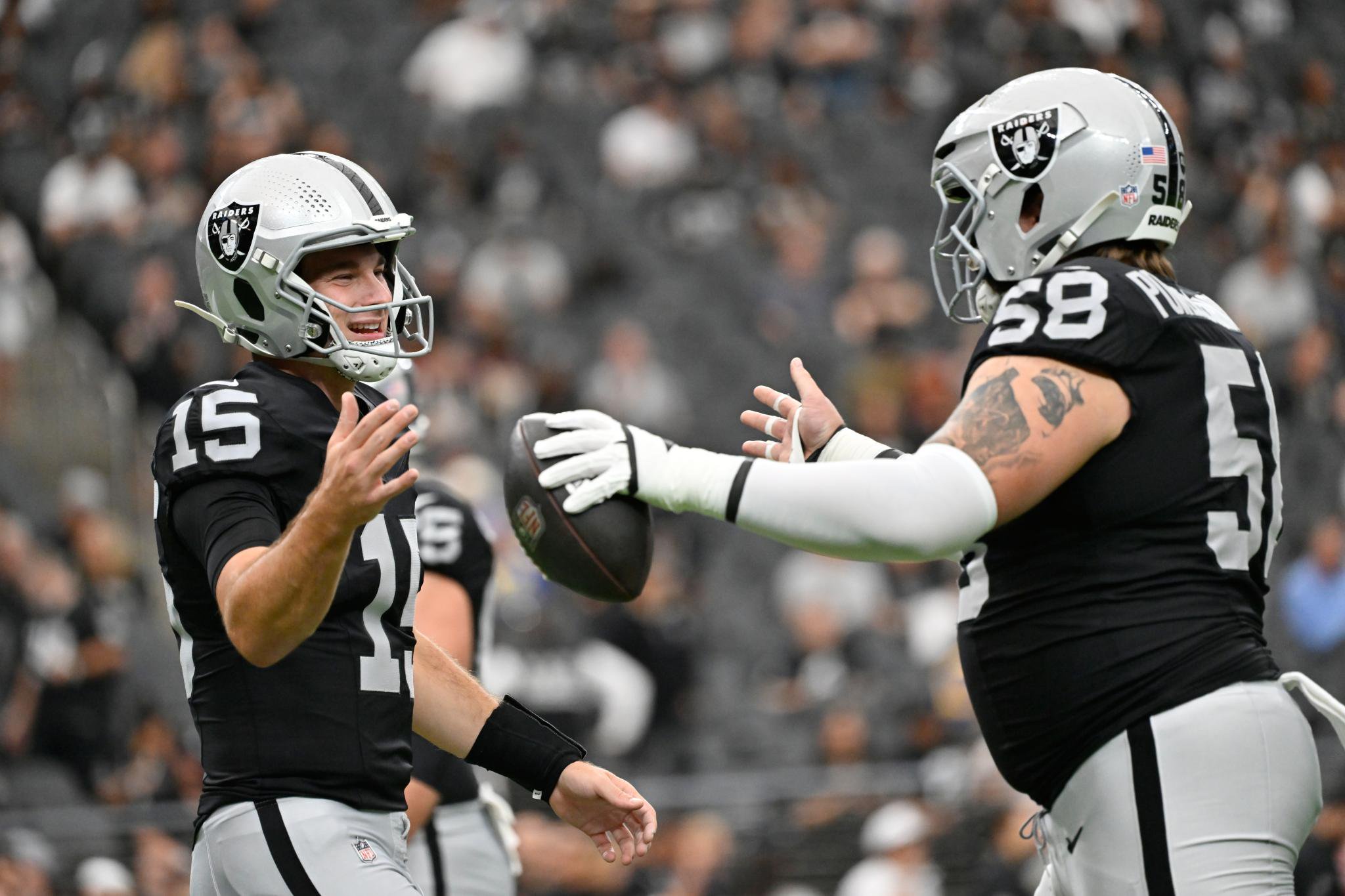 Raiders offensive lineman Jackson Powers-Johnson with quarterback Fernando Mendoza