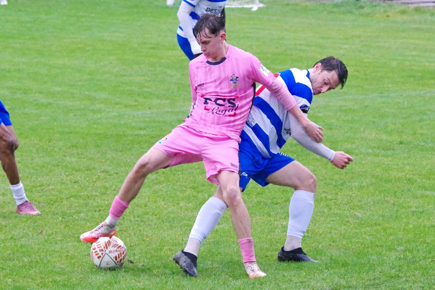 Kian Cocking holds off an Ilford defender