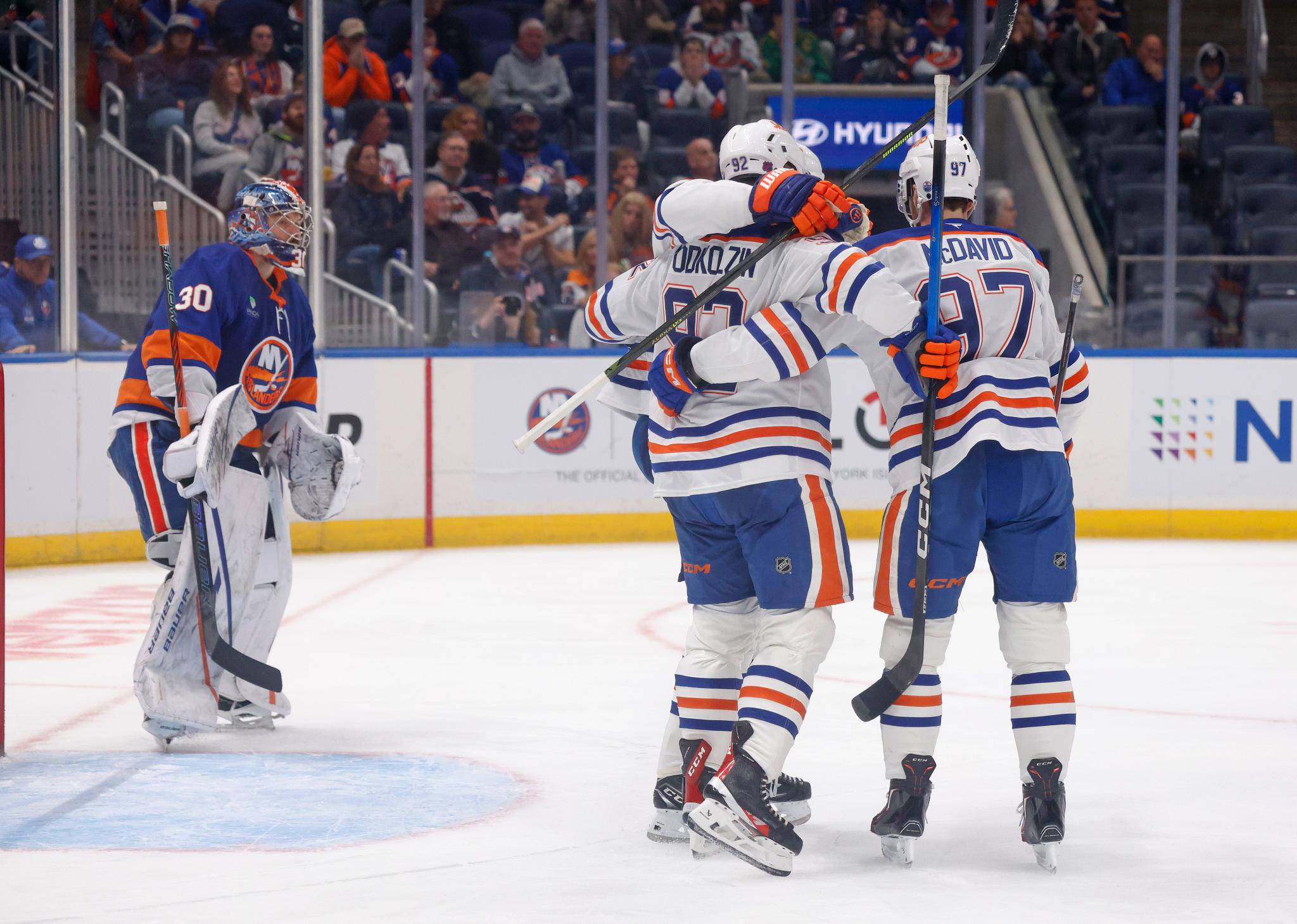 Edmonton Oilers right wing Vasily Podkolzin celebrates a goal with center Connor McDavid against the New York Islanders.