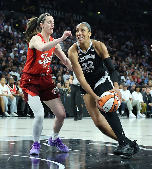 A'ja Wilson #22 of the Las Vegas Aces drives to the basket against Caitlin Clark #22 of the Indiana Fever in the first quarter of Game Three of the 2026 WNBA Playoffs first round at Michelob ULTRA Arena on Oct. 1, 2026 in Las Vegas