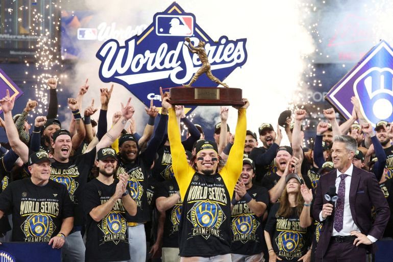 Oct 28, 2026; St. Petersburg, Florida, USA; Milwaukee Brewers catcher William Contreras (24) celebrates with the MVP trophy after defeating the Tampa Bay Rays in game five of the 2026 World Series at Tropicana Field. Mandatory Credit: Nathan Ray Seebeck-Imagn Images TPX IMAGES OF THE DAY