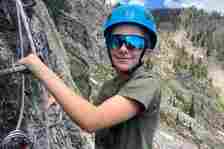 Climber on a rocky via ferrata route