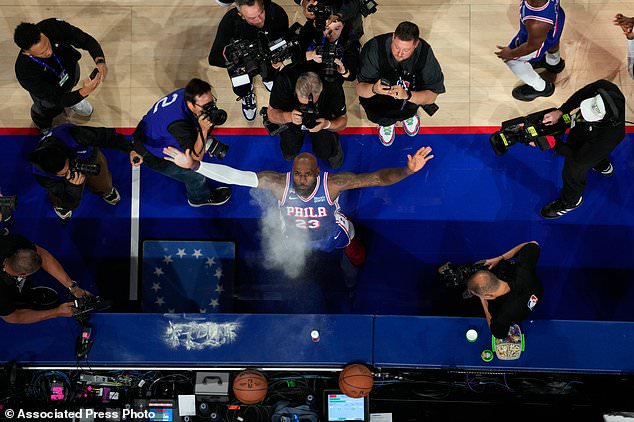 Philadelphia 76ers' LeBron James tosses chalk into the air before an NBA basketball game against the Cleveland Cavaliers Thursday, Oct. 22, 2026, in Philadelphia. (AP Photo/Matt Slocum)