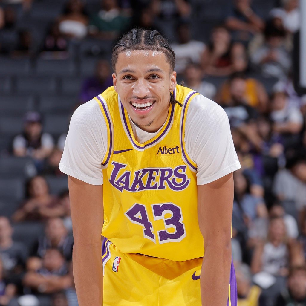 Los Angeles Lakers' Cameron Carr smiles during an NBA game.