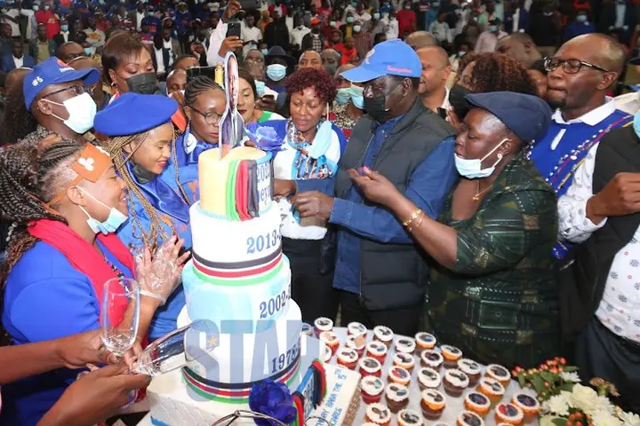 Raila Odinga flanked with his sister Ruth Odinga cut a cake during his birthday party at Bomas of Kenya on January 7, 2022.