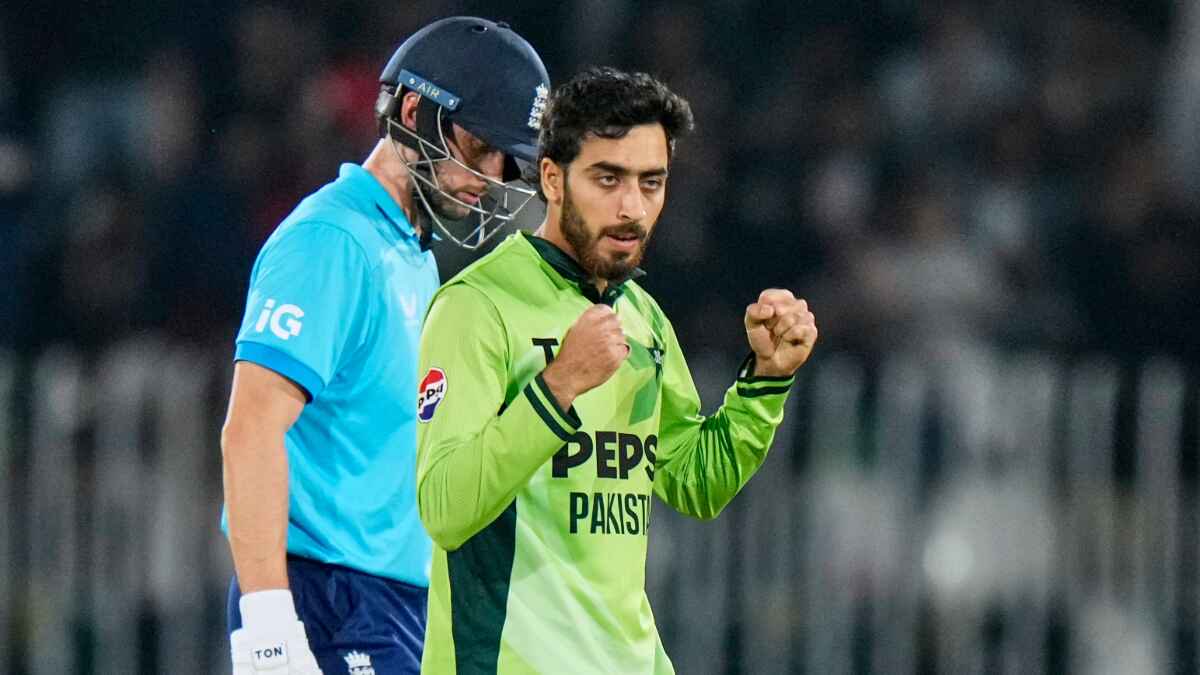 Arafat Minhas, right, celebrates after taking the wicket of Jamie Overton.