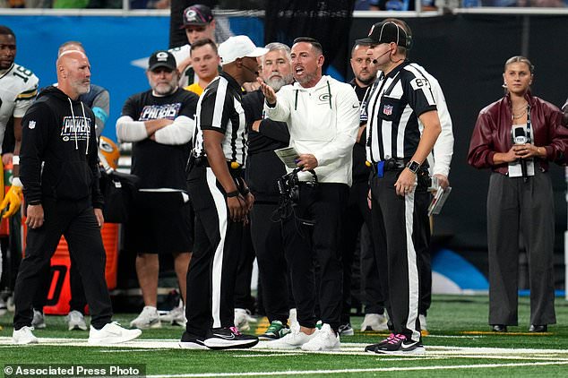 Green Bay Packers head coach Matt LaFleur, center, questions a call during the second half of an NFL football game against the Detroit Lions, Sunday, Oct. 25, 2026, in Detroit. (AP Photo/Paul Sancya)