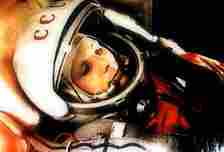 Yuri Gagarin, in spacesuit and helmet, shot at an angle. 