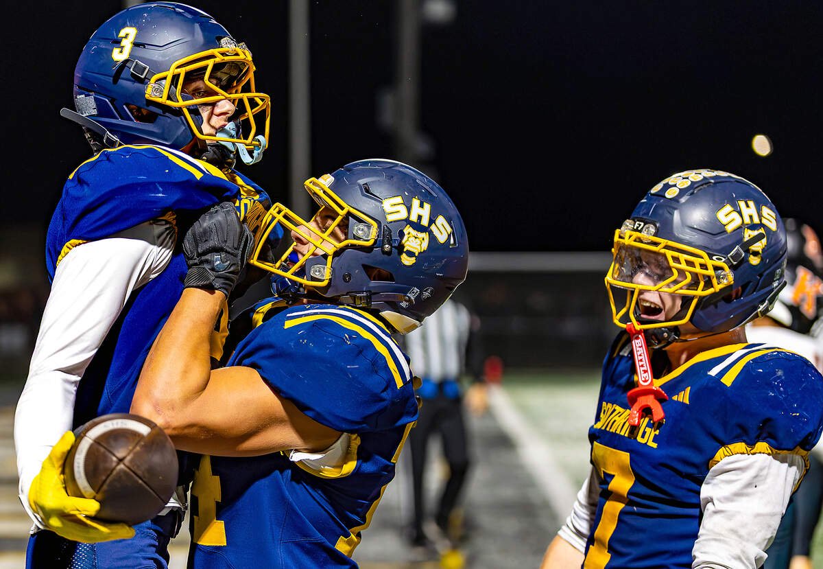 Southridge's Stockton Parrish (3) celebrates after catching a touchdown pass from Tayton Jackman (2) as teammate Hugo Godinez Mendoza (74) lifts him off the ground during the Suns' game against Kennewick Thursday at Neil F. Lampson Stadium in Kennewick.