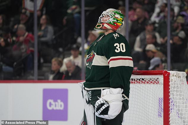 Minnesota Wild goaltender Jesper Wallstedt looks at the replay board after a goal by Columbus Blue Jackets center Adam Fantilli during the first period of an NHL hockey game, Sunday, Oct. 18, 2026, in St. Paul, Minn. (AP Photo/Abbie Parr)