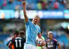Erling Haaland of Manchester City gives a thumbs up to fans at full time holding his hat-trick ball following the Premier League match between Manc...