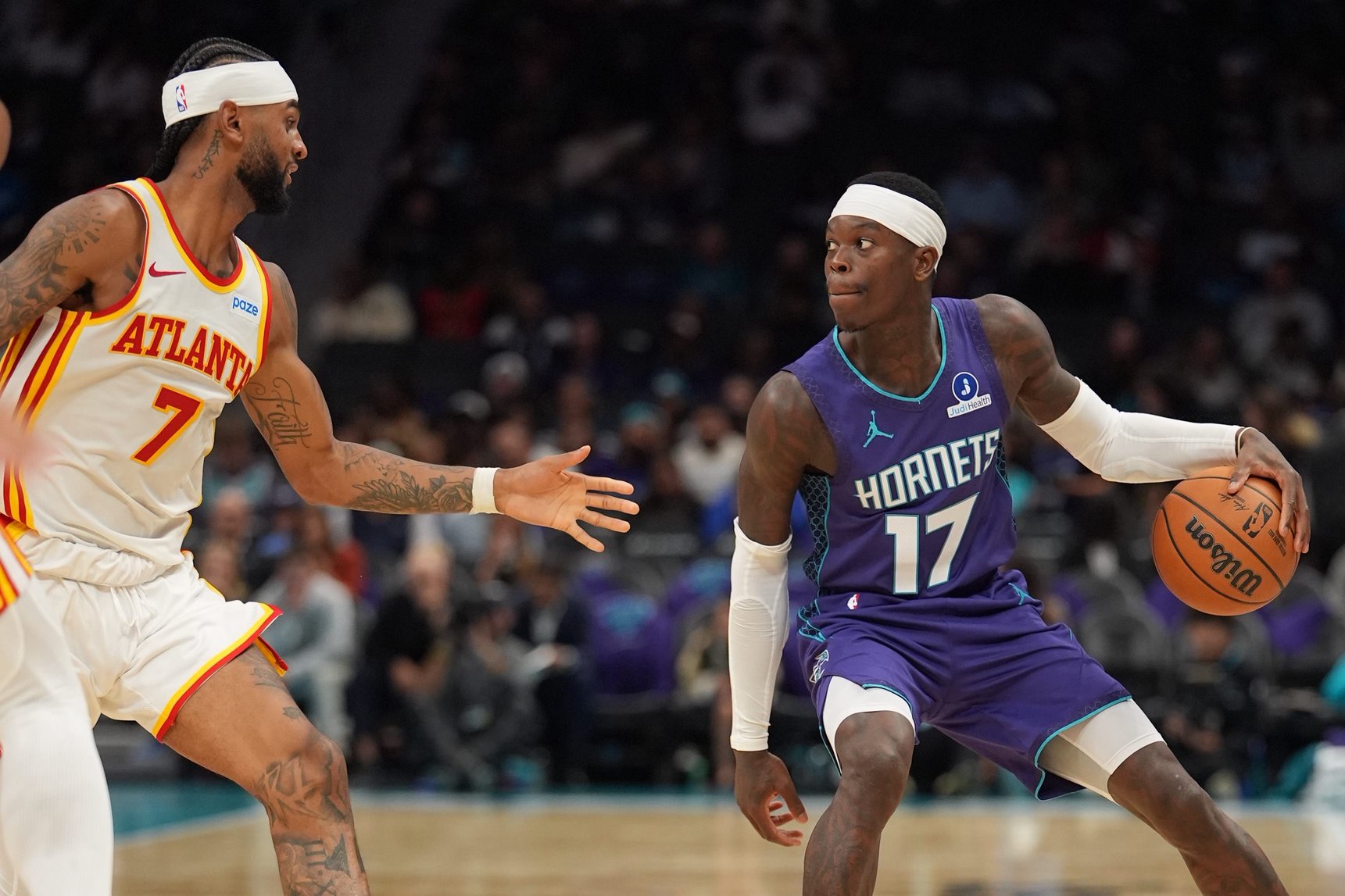 Oct 23, 2026; Charlotte, North Carolina, USA;  Charlotte Hornets guard Dennis Schroder (17) looks to pass guarded by Atlanta Hawks guard Nickeil Alexander-Walker (7) during the second half at the Spectrum Center.  Mandatory Credit: Jim Dedmon-Imagn Images