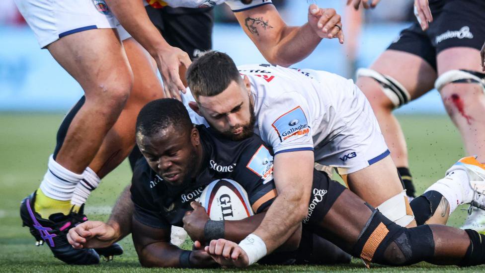 Rotimi Segun has the ball on the floor with Newcastle forward Max Hicks on top of him