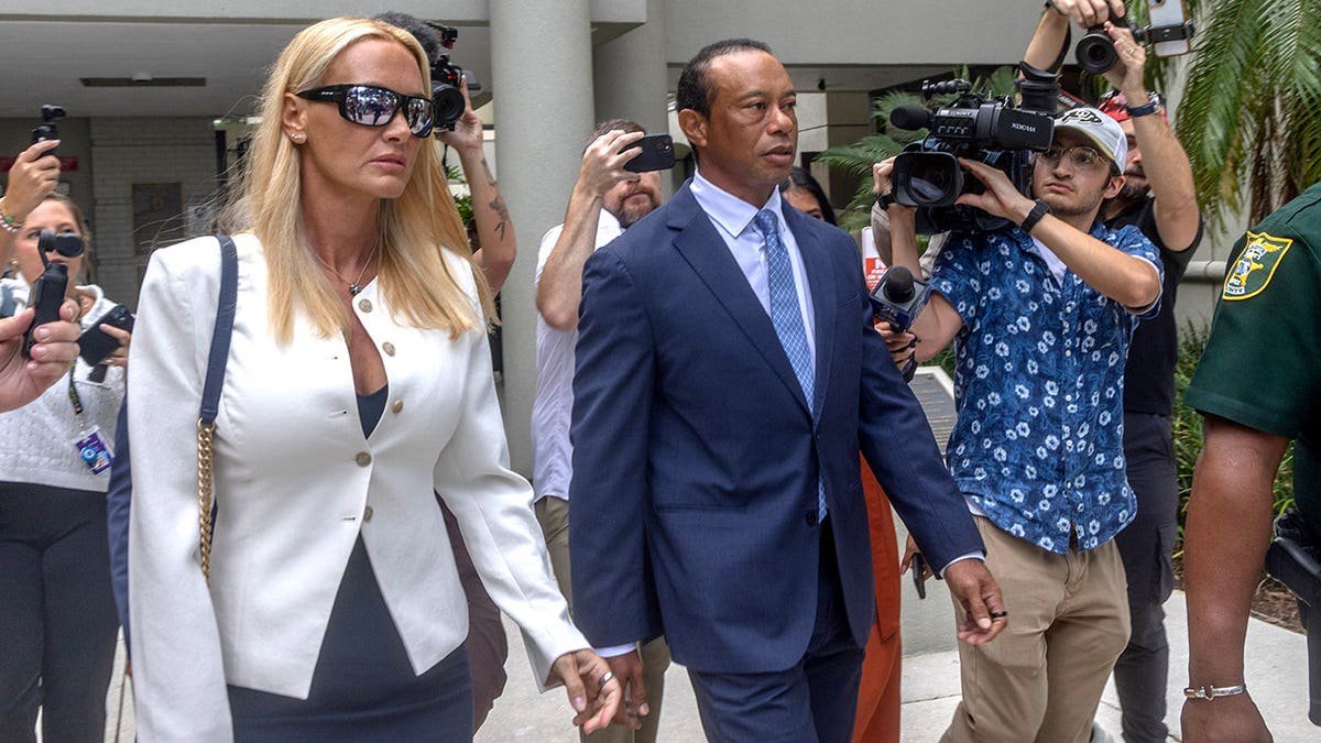Vanessa Trump walks with Tiger Woods