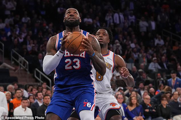 Philadelphia 76ers forward LeBron James (23) drives as New York Knicks forward Og Anunoby defends during the second half of an NBA basketball game Tuesday, Oct. 20, 2026, in New York. (AP Photo/Frank Franklin II)