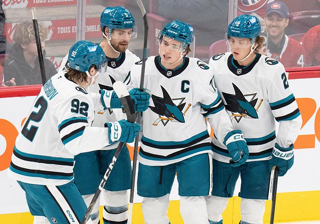 San Jose Sharks' Macklin Celebrini (71) celebrates his goal over the Montreal Canadiens with teammates from left, Igor Chernyshov (92), Nolan Allan (5) and Will Smith (2) during the first period of an NHL hockey game in Montreal on Tuesday, Oct. 20, 2026. (Christinne Muschi/The Canadian Press via AP)