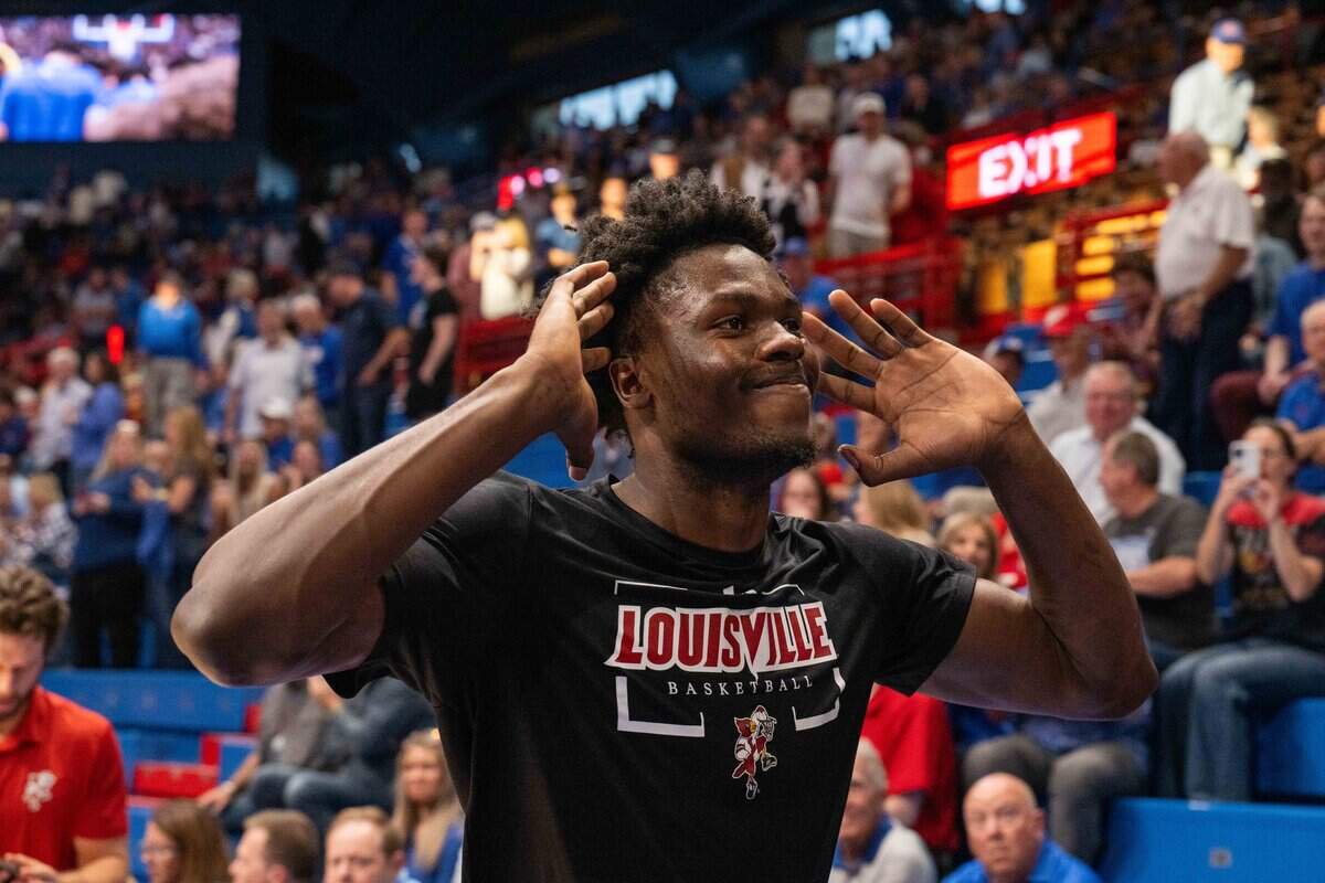 Louisville Cardinals forward Flory Bidunga (40) puts his hands to his ears as he was booed walking off the court at Allen Fieldhouse on Wednesday, October 21, 2026. Louisville faced the Kansas Jayhawks in an exhibition game.
