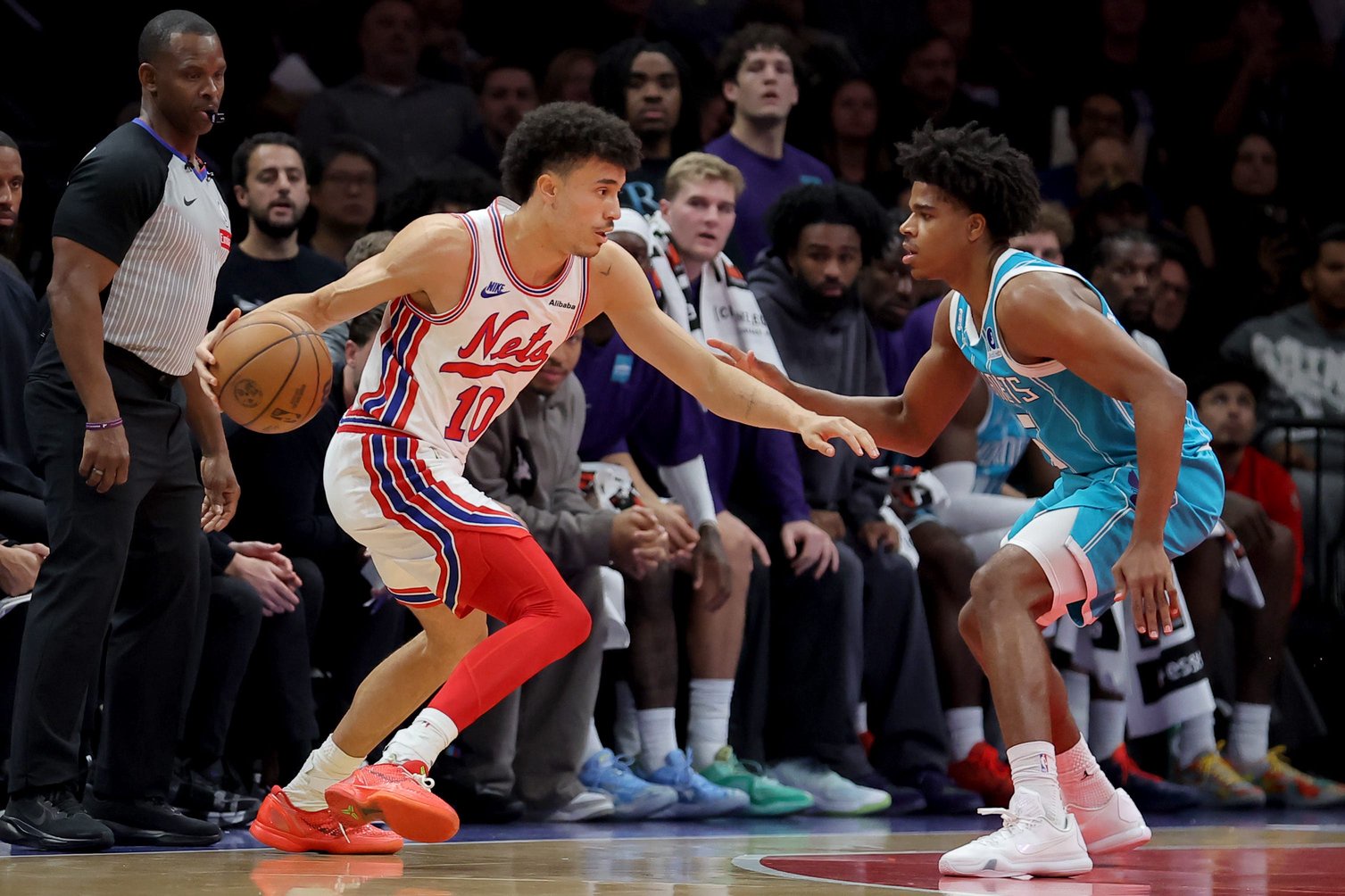 Oct 21, 2026; Brooklyn, New York, USA; Brooklyn Nets guard Nolan Traore (10) controls the ball against Charlotte Hornets guard Christian Anderson (5) during the first quarter at Barclays Center. Mandatory Credit: Brad Penner-Imagn Images