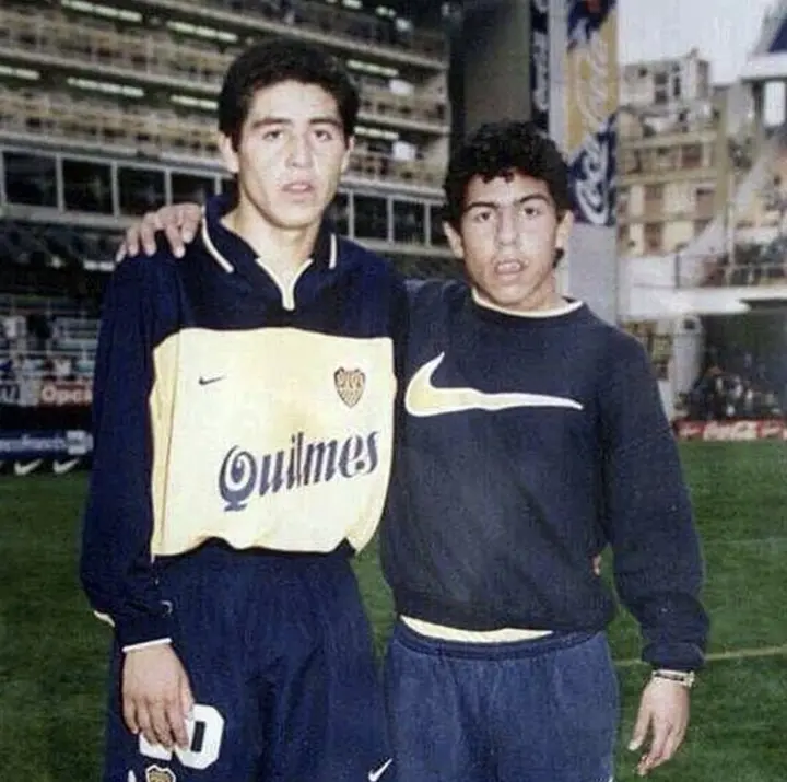 A young Tevez poses with Juan Roman Riquleme before ball boy duty at Boca