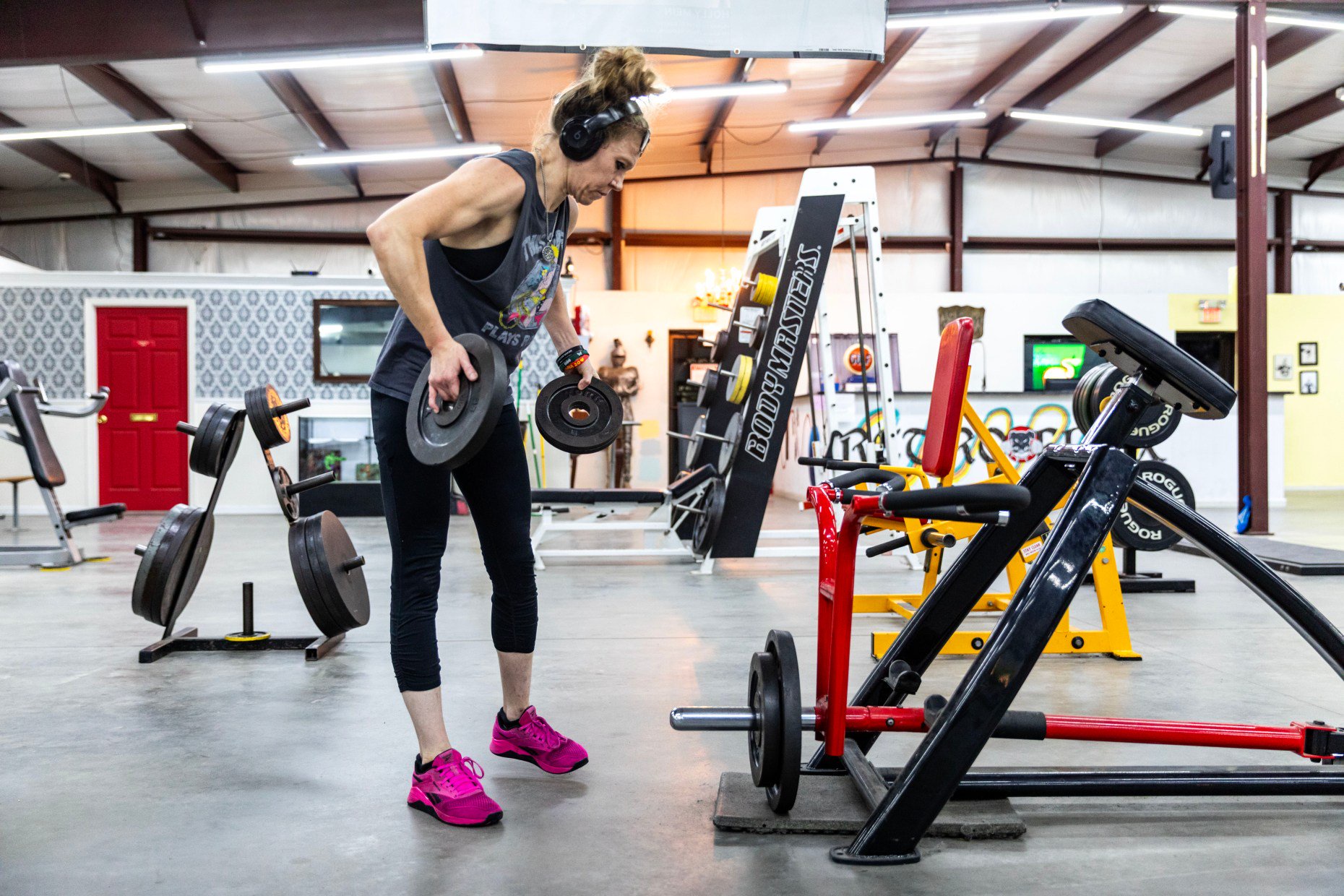 Arlyn Smith racks weights during her workout at Retro Flex...