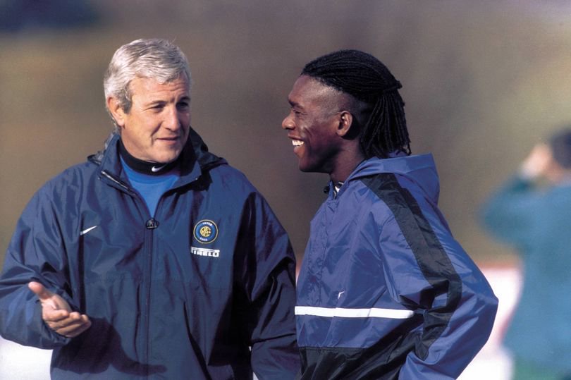 Clarence Seedorf and Marcello Lippi talk together.