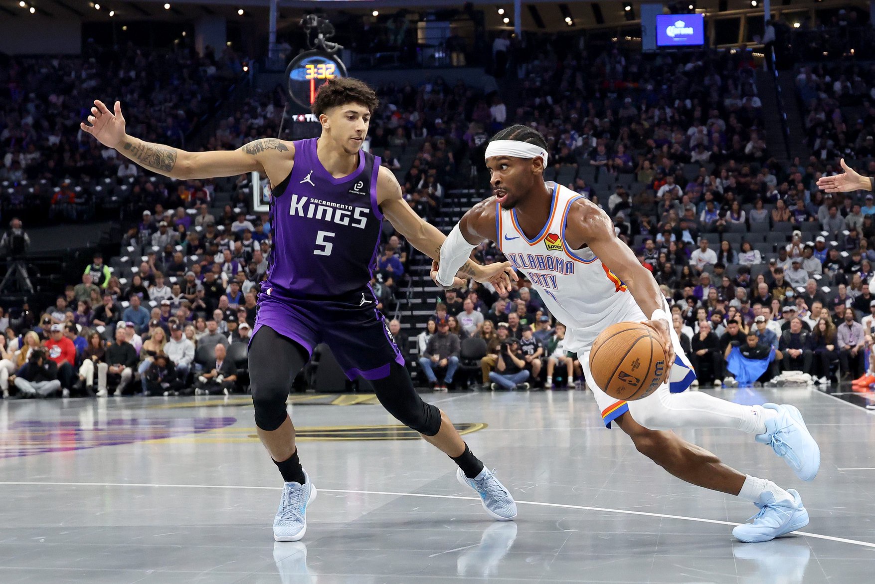 SACRAMENTO, CALIFORNIA - NOVEMBER 07: Shai Gilgeous-Alexander #2 of the Oklahoma City Thunder is guarded by Nique Clifford #5 of the Sacramento Kings during the first quarter at Golden 1 Center on November 07, 2025 in Sacramento, California. NOTE TO USER: User expressly acknowledges and agrees that, by downloading and/or using this photograph, user is consenting to the terms and conditions of the Getty Images License Agreement. (Photo by Ezra Shaw/Getty Images)