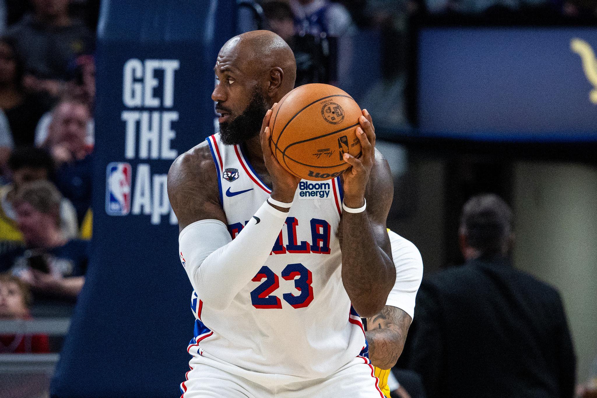 Philadelphia 76ers basketball player D.J. Wilson in a white jersey holding a basketball during a game against the Indiana Pacers.