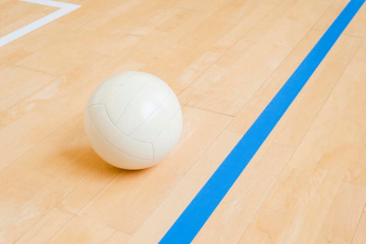 Volleyball ball on hardwood volleyball court