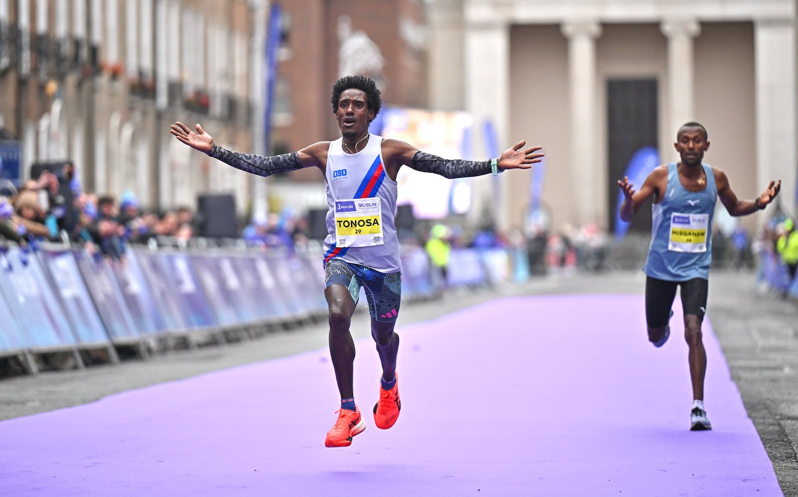Hiko Tonosa celebrates on his way to winning the Irish National Championships, and finshing third overall, during the 2024 Dublin Marathon. Photograph: Sam Barnes/Sportsfile