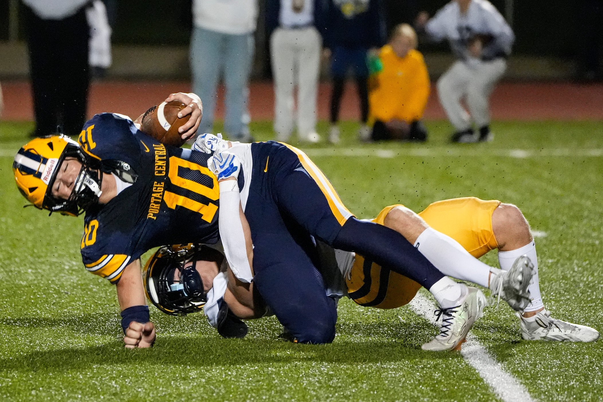 Portage Central quarterback Brady Putnam is sacked by Hudsonville’s Sam Radosa during the second half at Portage Central High School in Portage on Friday, Oct. 30, 2026.