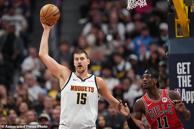 Denver Nuggets center Nikola Joki, left, looks to pass the ball as Chicago Bulls forward Leonard Miller defends in the second half of a preseason NBA basketball game Sunday, Oct. 11, 2026, in Denver. (AP Photo/David Zalubowski)