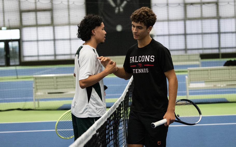 Jesus Lukas and Thomas Curci shake hands.
