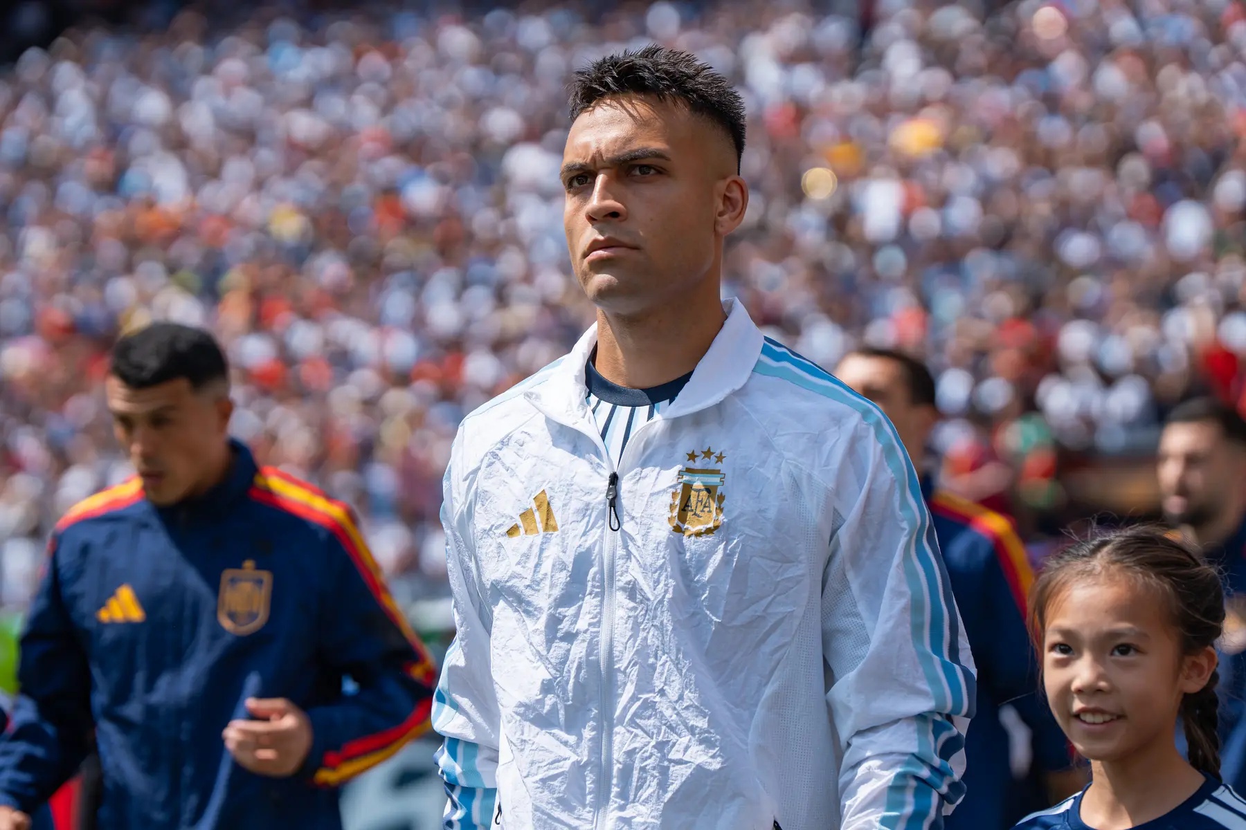 Lautaro Martinez wearing an Argentina national team jacket during a match against Spain.