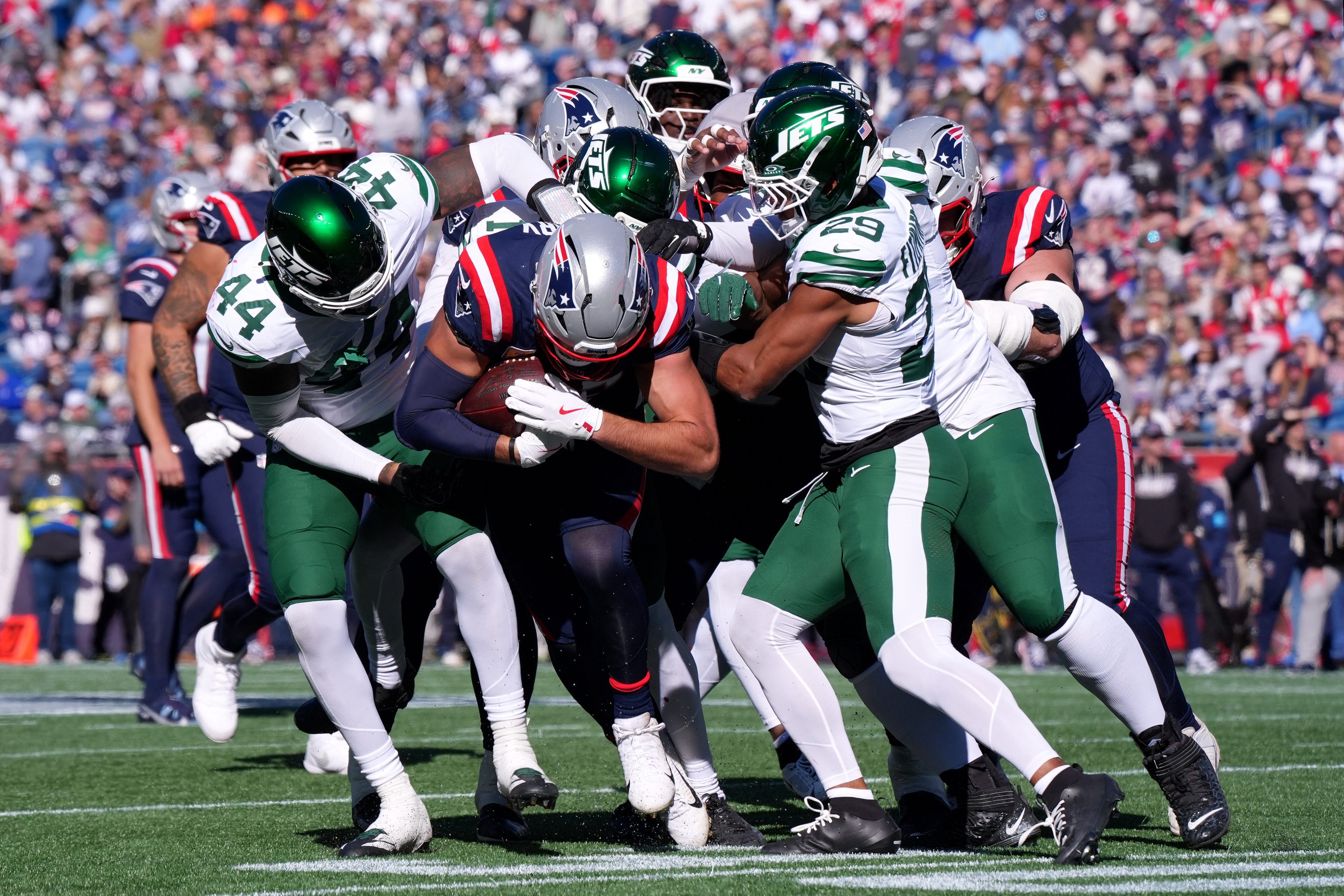 Oct 18, 2026; Foxborough, Massachusetts, USA;  New England Patriots tight end Hunter Henry (85) is tackled by New York Jets linebacker Jamien Sherwood (44) and cornerback Azareye'h Thomas (1) in the second quarter at Gillette Stadium.  Mandatory Credit: David Butler II-Imagn Images