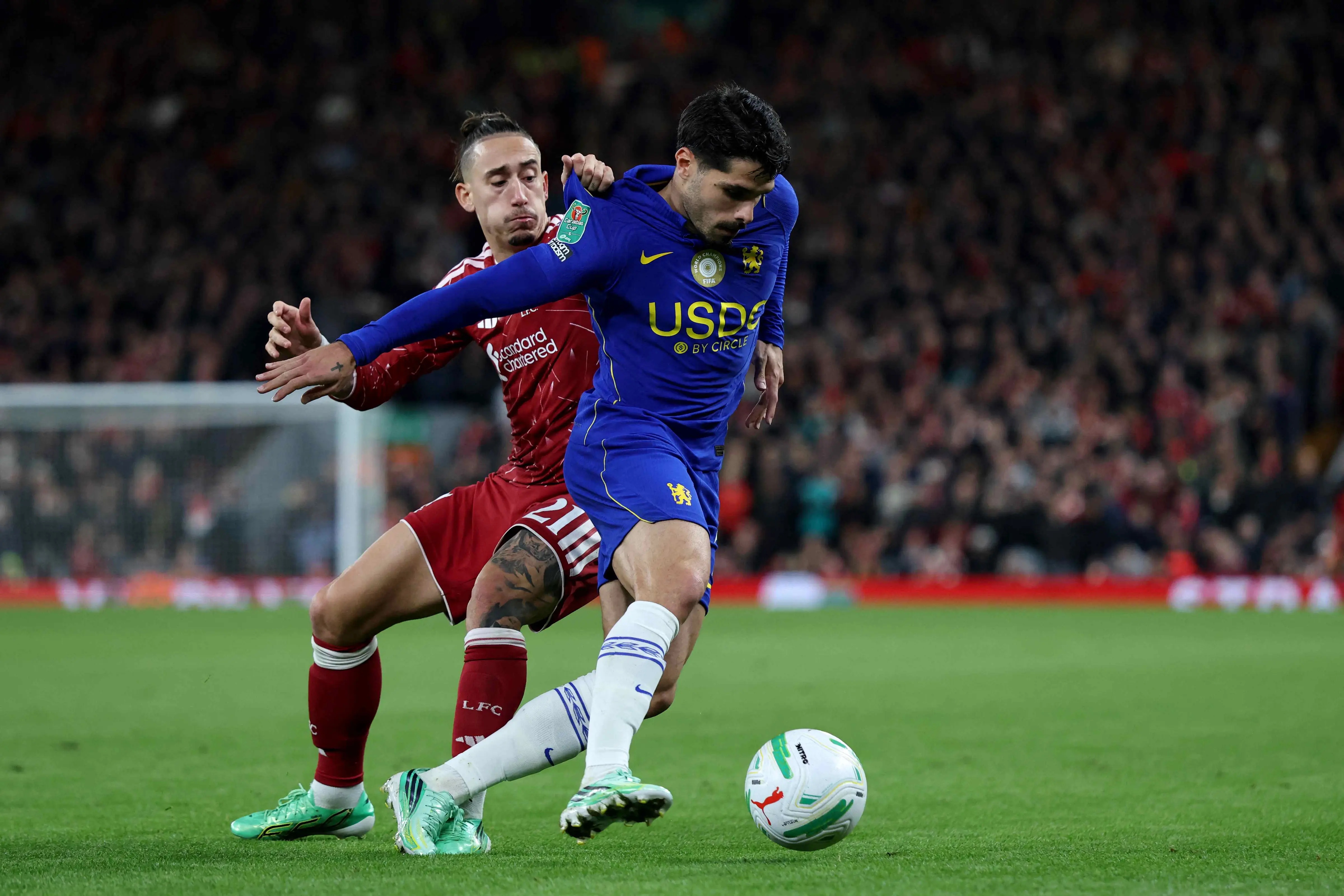 Liverpool's Greek defender Kostas Tsimikas pulls the shirt of Chelsea's Portuguese midfielder Pedro Neto during the English League Cup fourth round football match between Liverpool and Chelsea at Anfield in Liverpool, north west England on October 28, 2026.