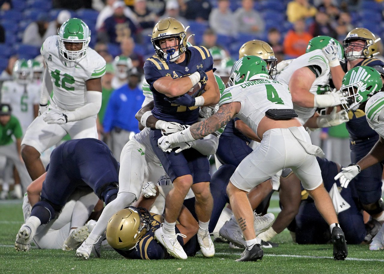 Navy Midshipmen fullback Vic Listorti #40 bursts through the North Texas Mean Green defense to pick up a first down in the fourth quarter. The visiting North Texas Mean Green defeat the Navy Midshipmen, 49-39, in an NCAA football game Saturday at Navy-Marine Corps Memorial Stadium in Annapolis. (Paul W. Gillespie/Staff)