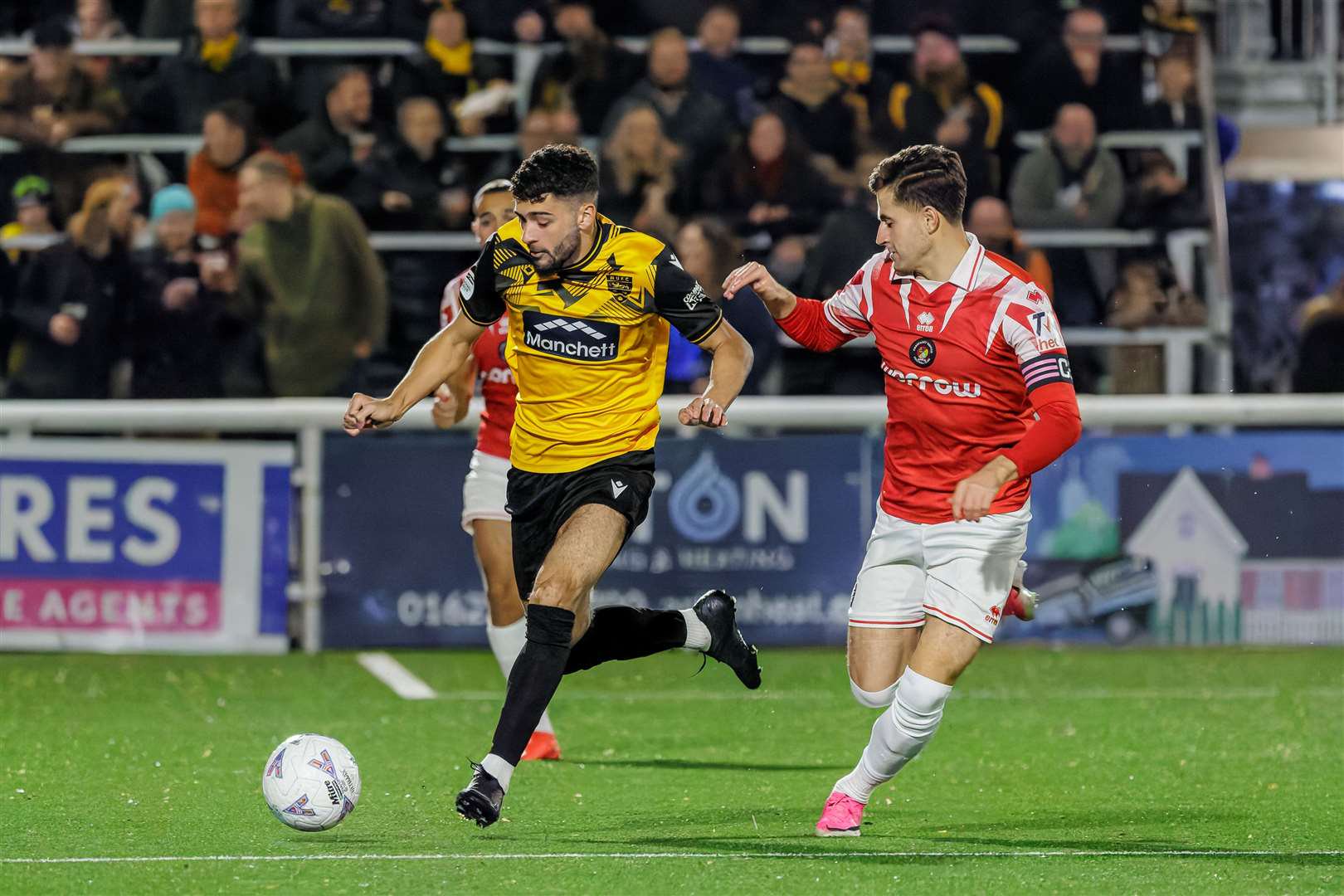 Tom Leahy gets away from Ebbsfleet captain James Vennings. Picture: Helen Cooper