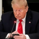 Warning in Gesture: Why Trump Quickly Got Off His Phone While in Court