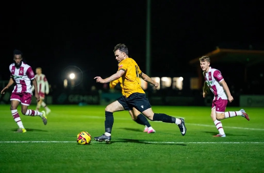 Conor Tee of Real Bedford running clear of two Stourbridge defenders at the Ledger Stadium