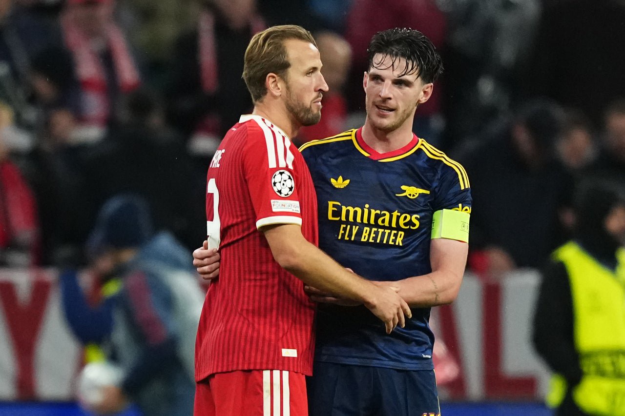Harry Kane (left) and Declan Rice embrace after full-time at the Allianz Arena (AP)