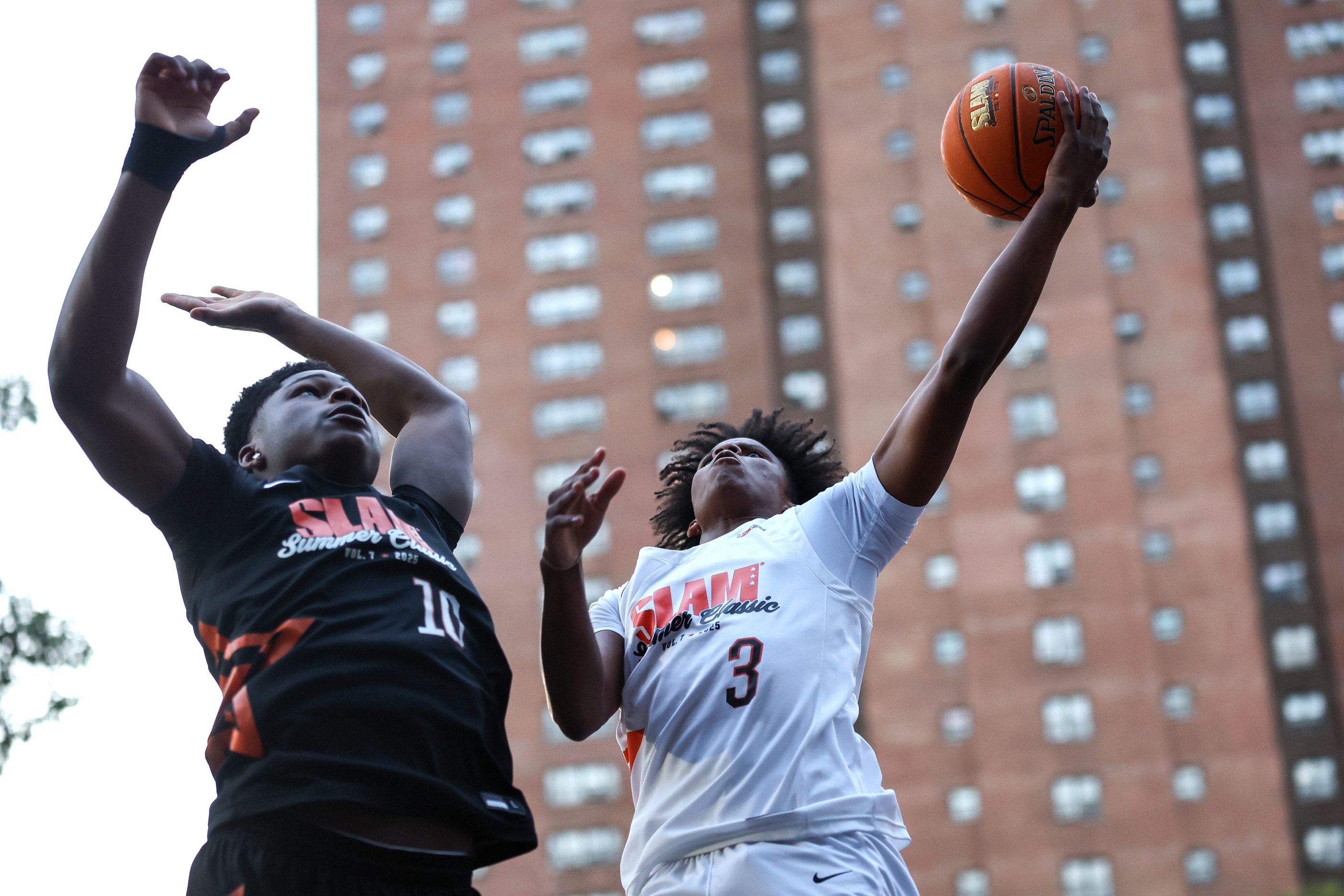 NEW YORK, NEW YORK - AUGUST 18: Class of 2027 recruit Anderson Diaz #3 shoots the ball while being guarded by Nasir Anderson #10 during the SLAM Summer Classic at Rucker Park on August 18, 2025 in New York City. (Photo by Ishika Samant/Getty Images)