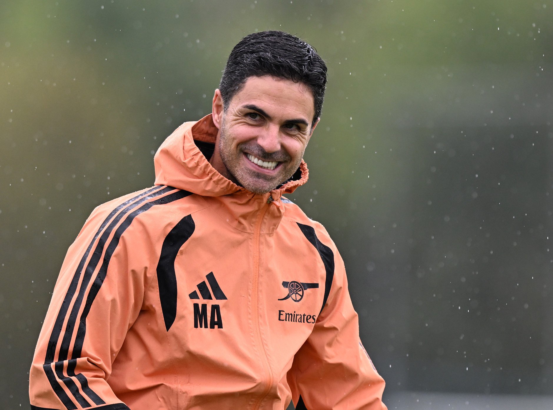 Arsenal manager Mikel Arteta smiles during a training session.