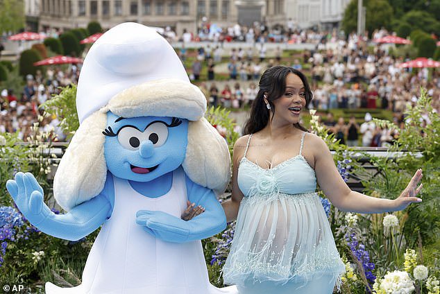 Feeling far from blue: Rihanna was seen earlier in Brussels, Belgium, as she got into the swing of all things Smurfs and posed at the movie's premiere with Smurfette, who she voiced