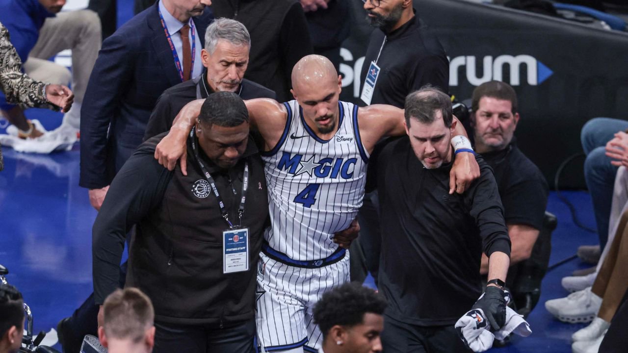 Oct 25, 2026; New York, New York, USA; Orlando Magic guard Jalen Suggs (4) is helped off the court after an injury in the fourth quarter against the New York Knicks at Madison Square Garden. Mandatory Credit: Wendell Cruz-Imagn Images