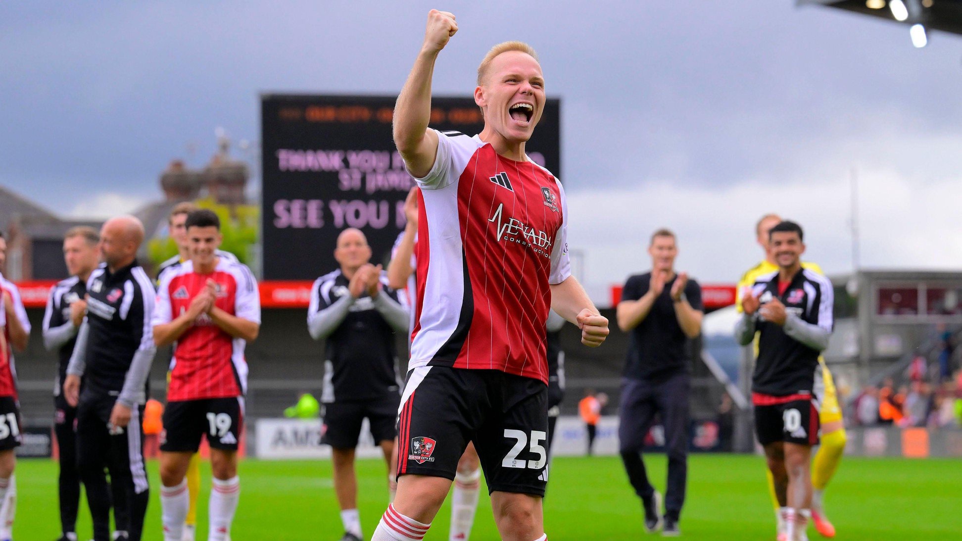 Anthony Scully celebrates in front of the Exeter City home fans