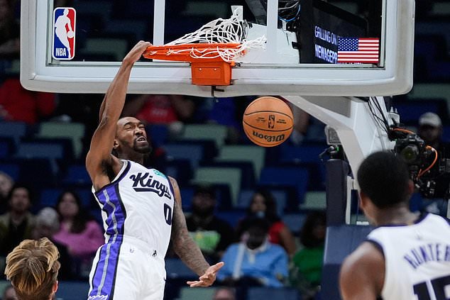 Sacramento Kings guard Malik Monk (0) slam dunks against the New Orleans Pelicans in the first half of an NBA basketball game, Thursday, Oct. 29, 2026, in New Orleans. (AP Photo/Gerald Herbert)