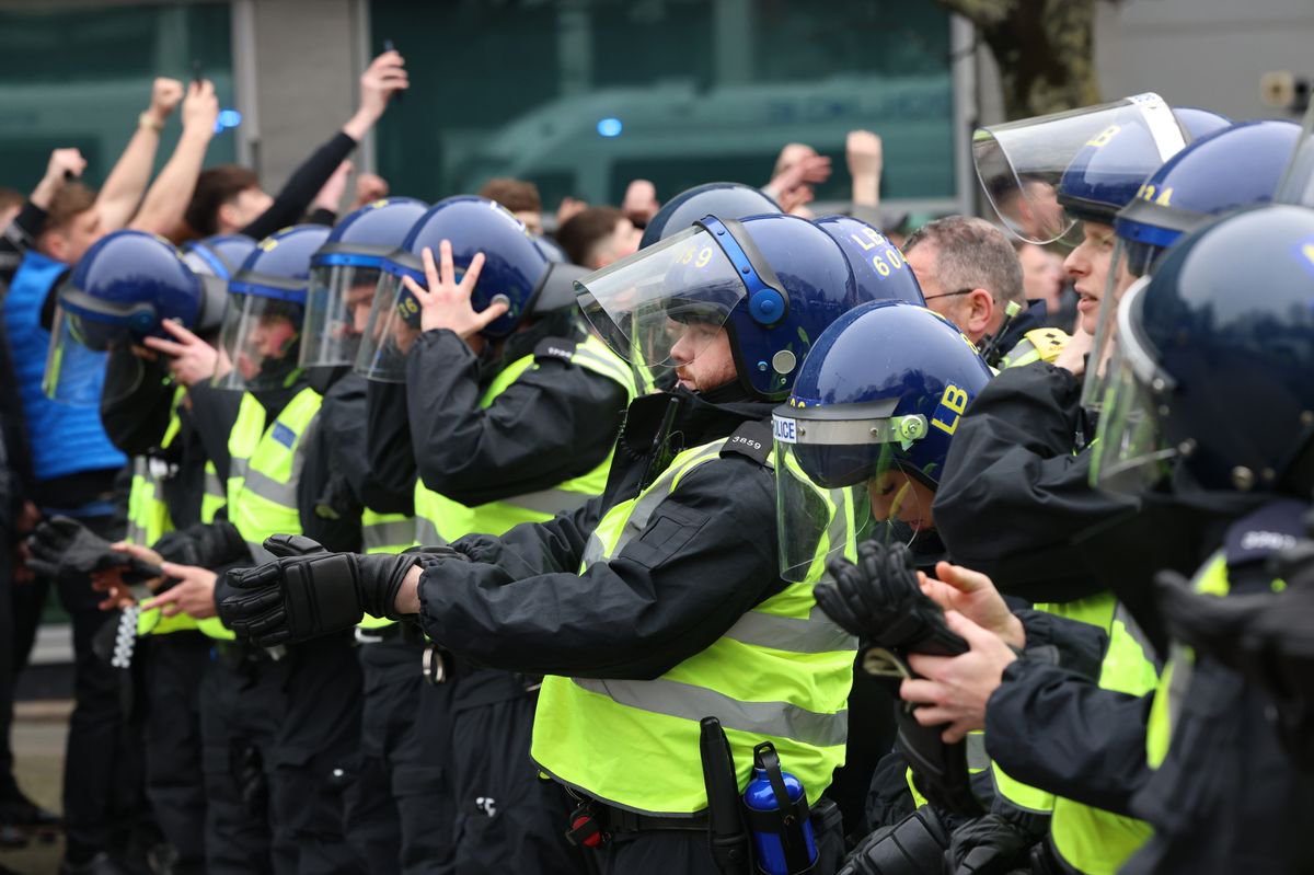 Police officers escort Sunderland AFC supporters from St James' Park to Newcastle Central Station after the Tyne and Wear Derby match against Newcastle United