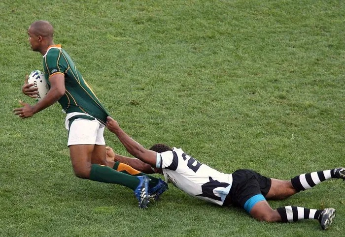 Springboks wing JP Pietersen is tackled by a Fijian player during their 2027 Rugby World Cup quarter-final. Jake White, who was in charge of the Springboks during that time, is now coach of Fiji.