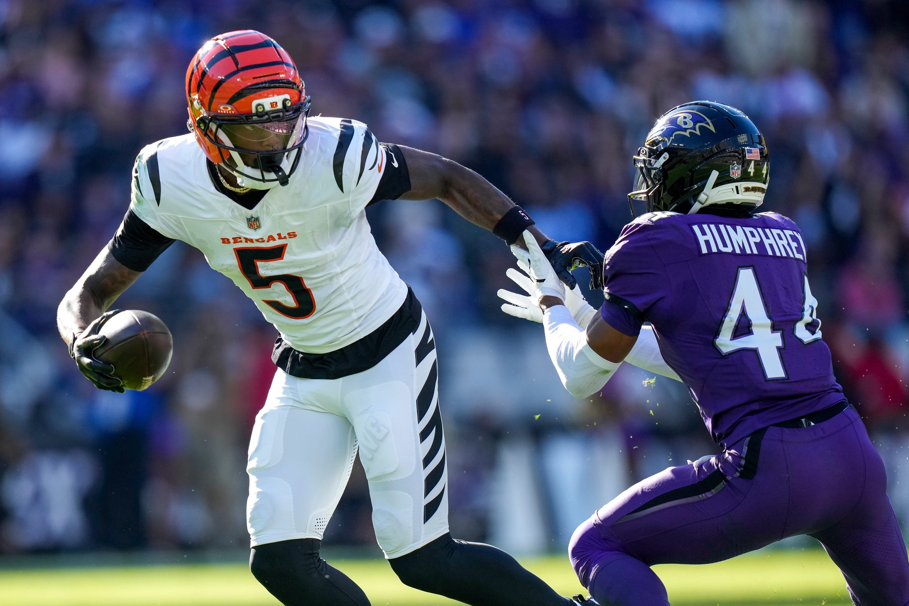 Cincinnati Bengals wide receiver Tee Higgins (5) fights off a tackle from Baltimore Ravens cornerback Marlon Humphrey (44) on a catch in the fourth quarter of the NFL Week 7 game between the Baltimore Ravens and the Cincinnati Bengals at M&amp;T Bank Stadium in Baltimore on Sunday, Oct. 25, 2026. The Bengals scored 35 points in the second half to win 35-13 on the road.